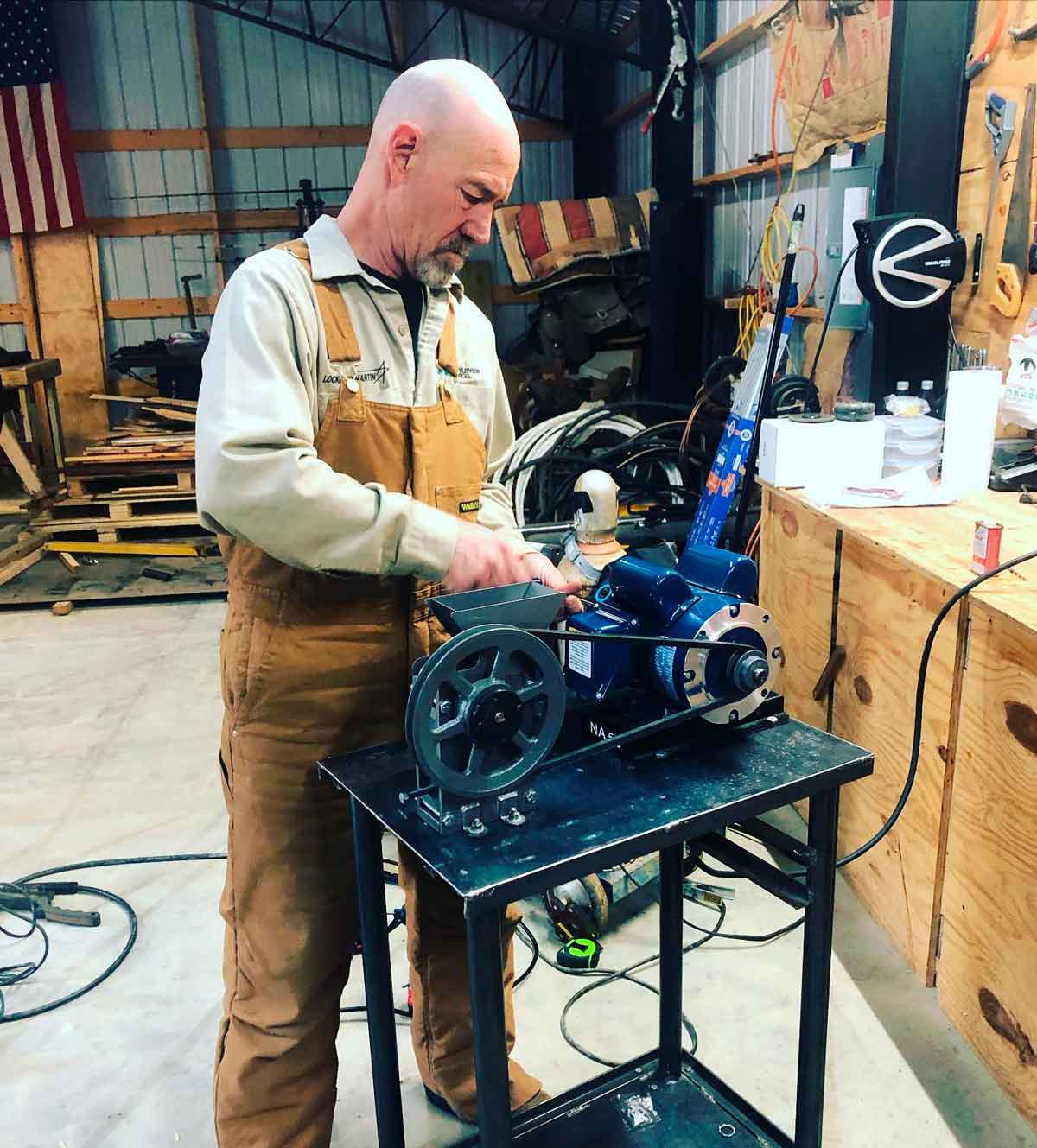 Rob putting the rock crusher together on the cart he fabricated from metal and pipe.