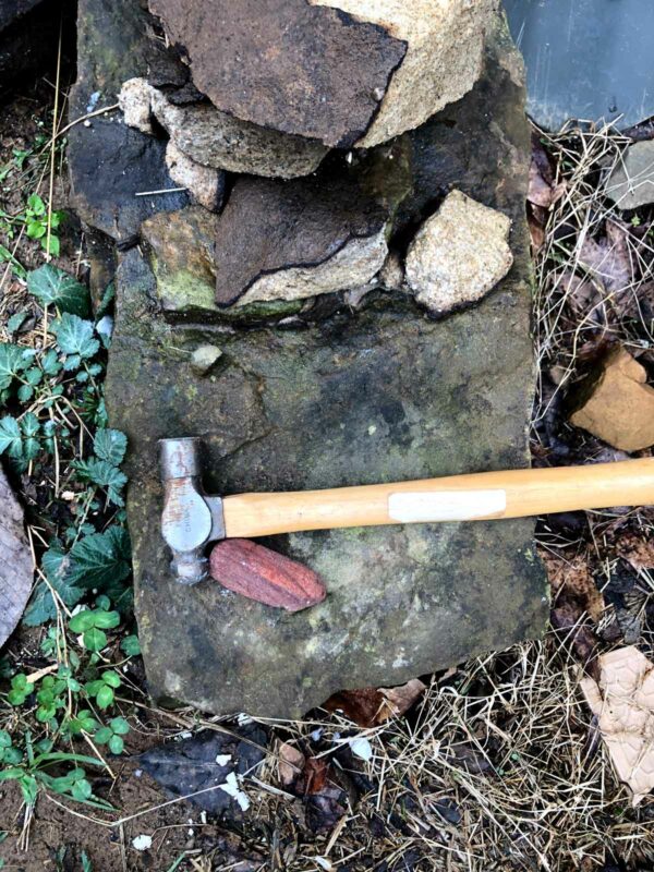 When making paint from rock dust, you have to break the rocks to manageable sizes first. This is my 'hammer rock',  where I break up large rocks into smaller rock pieces that can go into the crusher or mortar.