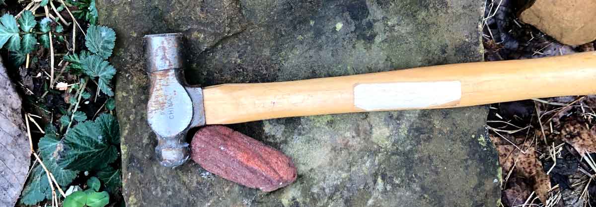 The hammer and rock I use to crush rocks to smaller chunks before making paint from rock dust.