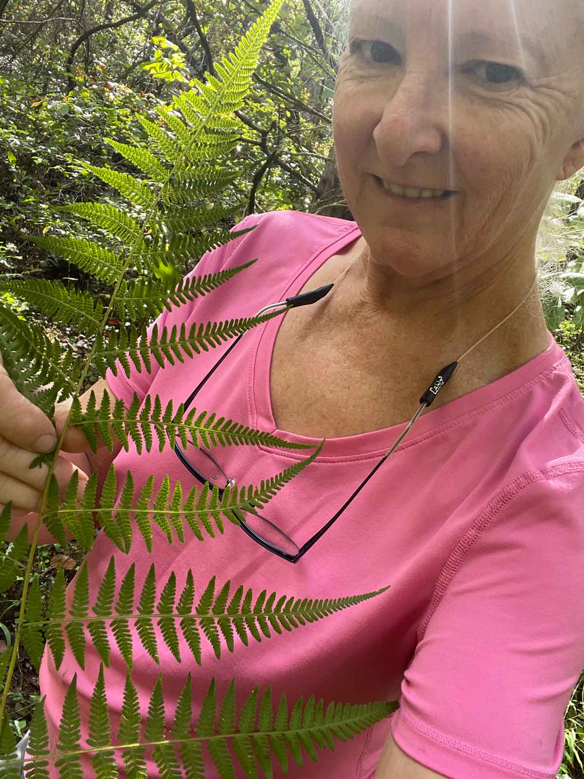 Madison Woods standing with a large frond.