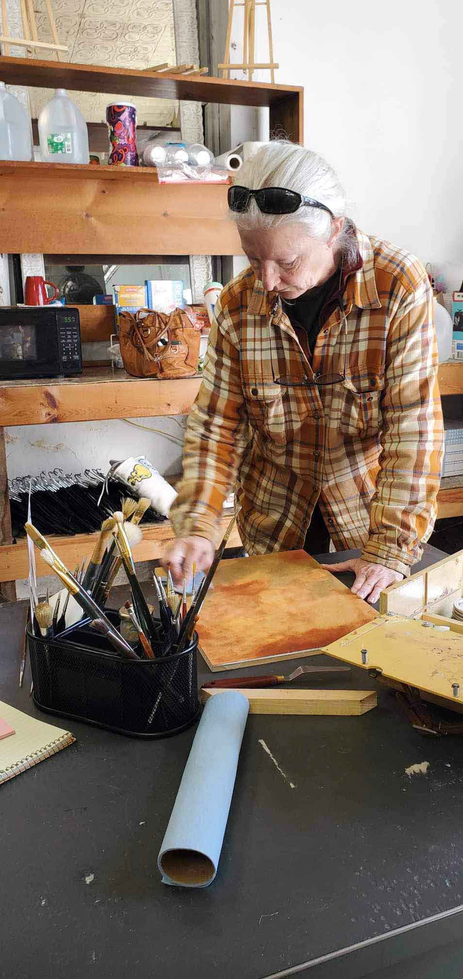 Madison Woods working on a painting in her studio.